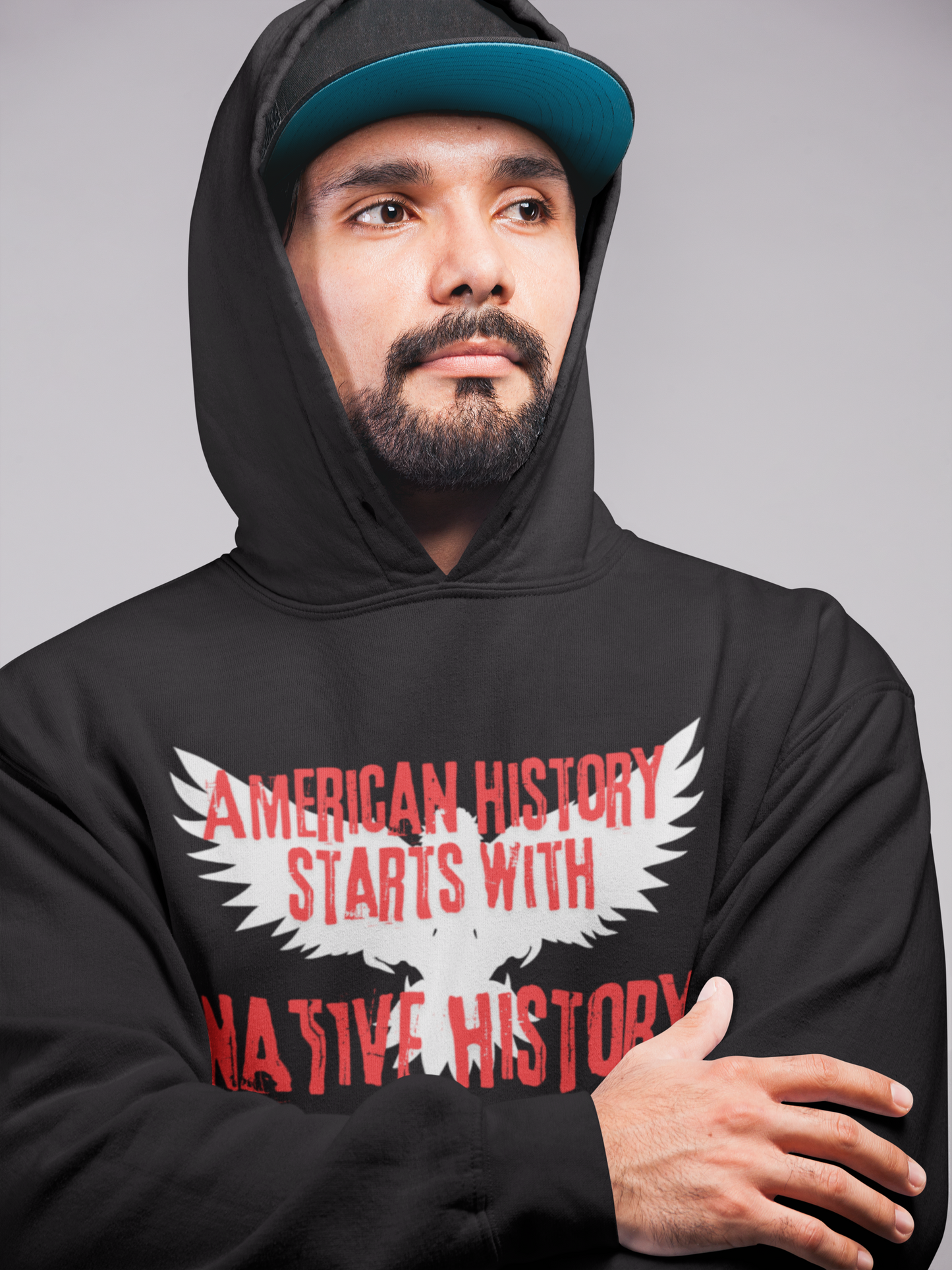 White outline of an eagle with its wings open in the background, American History Starts With Native History printed in red bold cracked font  - Black Hoodie