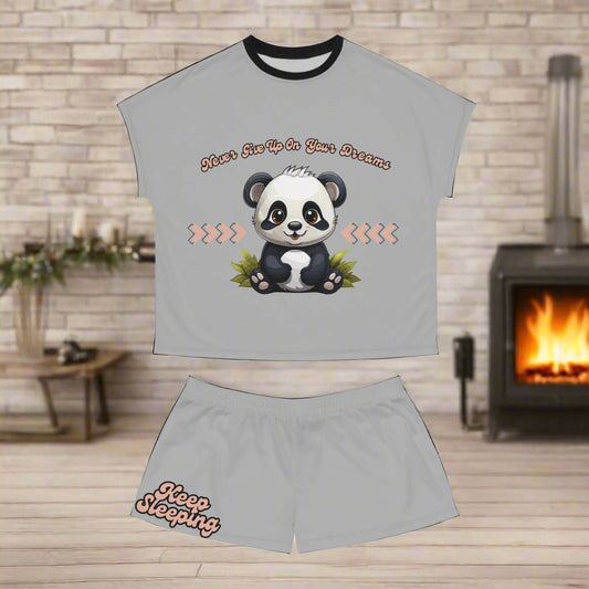 these adorable panda pajamas feature an animated panda in the center with Never give up on your dreams printed above it in retro font. The shorts feature a small detail on the leg of shorts that says Keep Sleeping