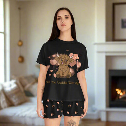 Scottish Highland Cow Women's Pajama tshirt and shorts set - All Black with an adorable Scottish highland cow  with pink hearts floating in the background. Will you cuddle with me? is printed underneath in yellow. Black shorts with Pink cow hoof prints all over printed. 