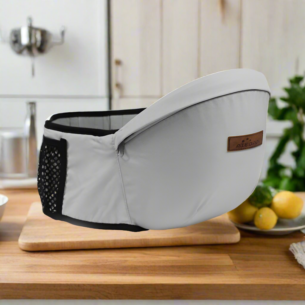 Baby hip carrier in grey. Clip this belt on and continue your day. Relieve back pain from holding your baby. For mom's, Dad's,  siblings, and anybody who wants hold an adorable baby. Versatile so you can hold your baby facing toward and away from you.