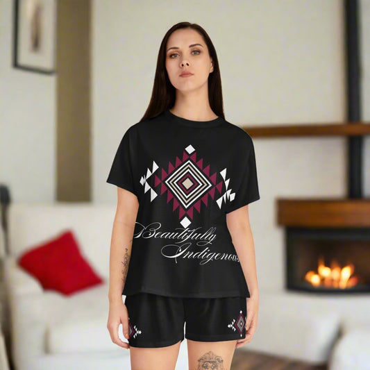 Beautifully Indigenous printed in bold cursive font. a beautiful tribal pattern printed in beige, white, and burgundy. The tribal pattern in also printed on both legs of the shorts