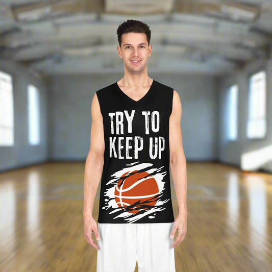 Black basketball jersey with an orange basketball on a white background with slash marks through it across the belly. White cracked font prints Try to keep up across the chest