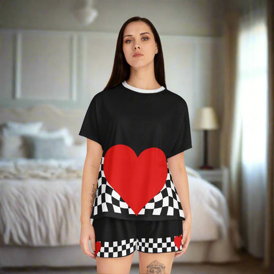 Black tshirt and shorts pajama set with a white collar. Waved checkered pattern across the bottom of the shirt with a large red heart in the center. The same pattern printed on both legs of the shorts.