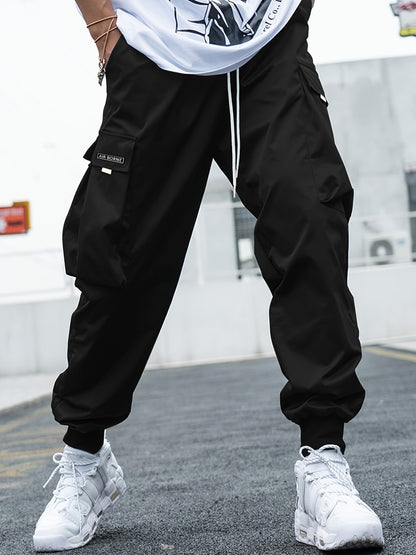 Make an absolute statement and elevate your streetwear game with these Oversized Men's Cargo Pants. The pockets are functional, and the oversized design delivers complete comfort. Versatile enough to be dressed up or down. - black