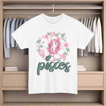 Pisces Horoscope Tshirt with 2 pink pisces fish surround with a light brown stem twisted into a circle with green leaves and pink flowers. Underneath Pisces is printed in light green font with navy blue shadow on a white shirt