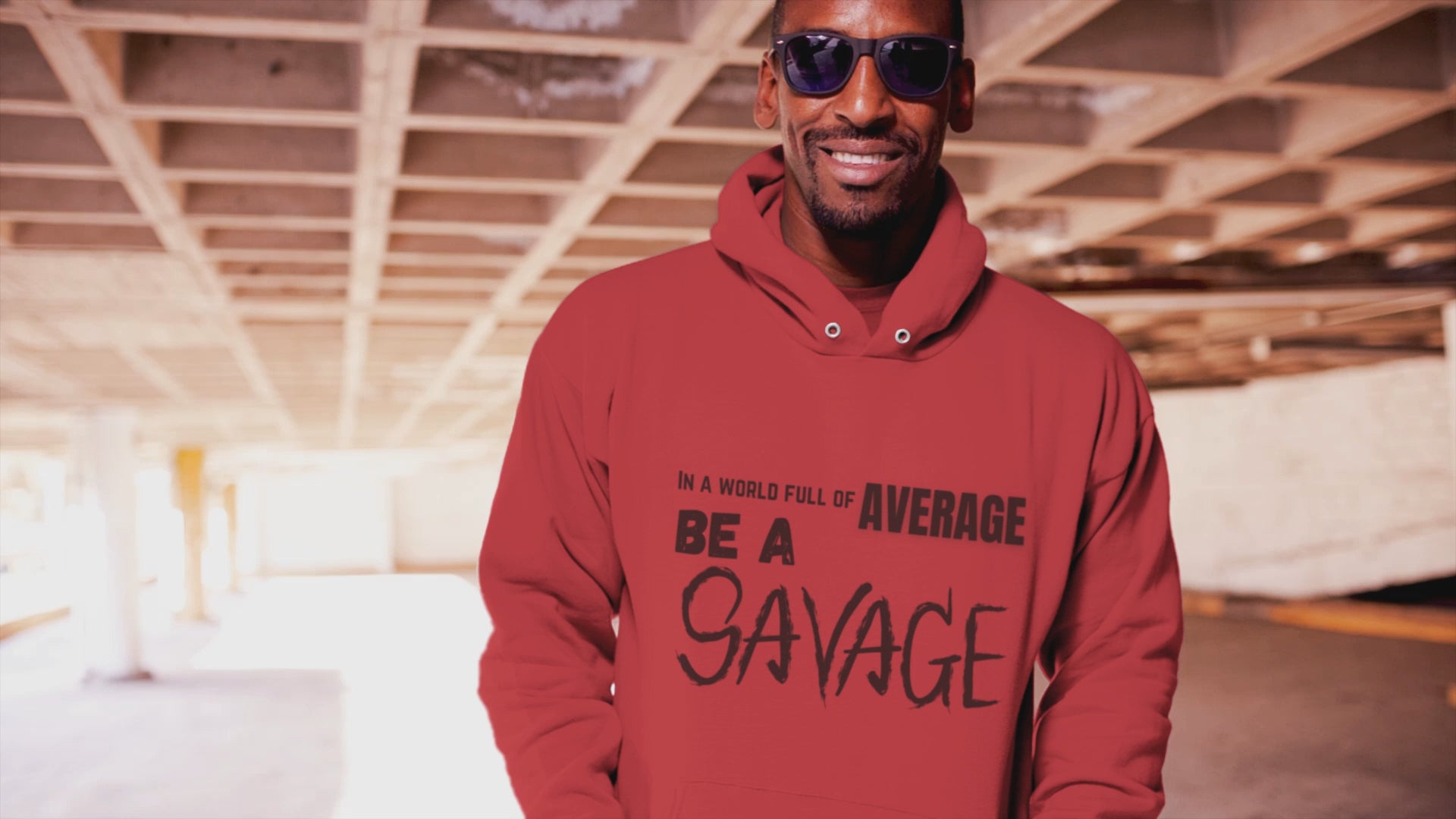 In a world full of average be a Savage. Printed on a soft, breathable hoodie. The top font is standard, average is gold, be a is bolder, and SAVAGE is in a scratched looking font. Red