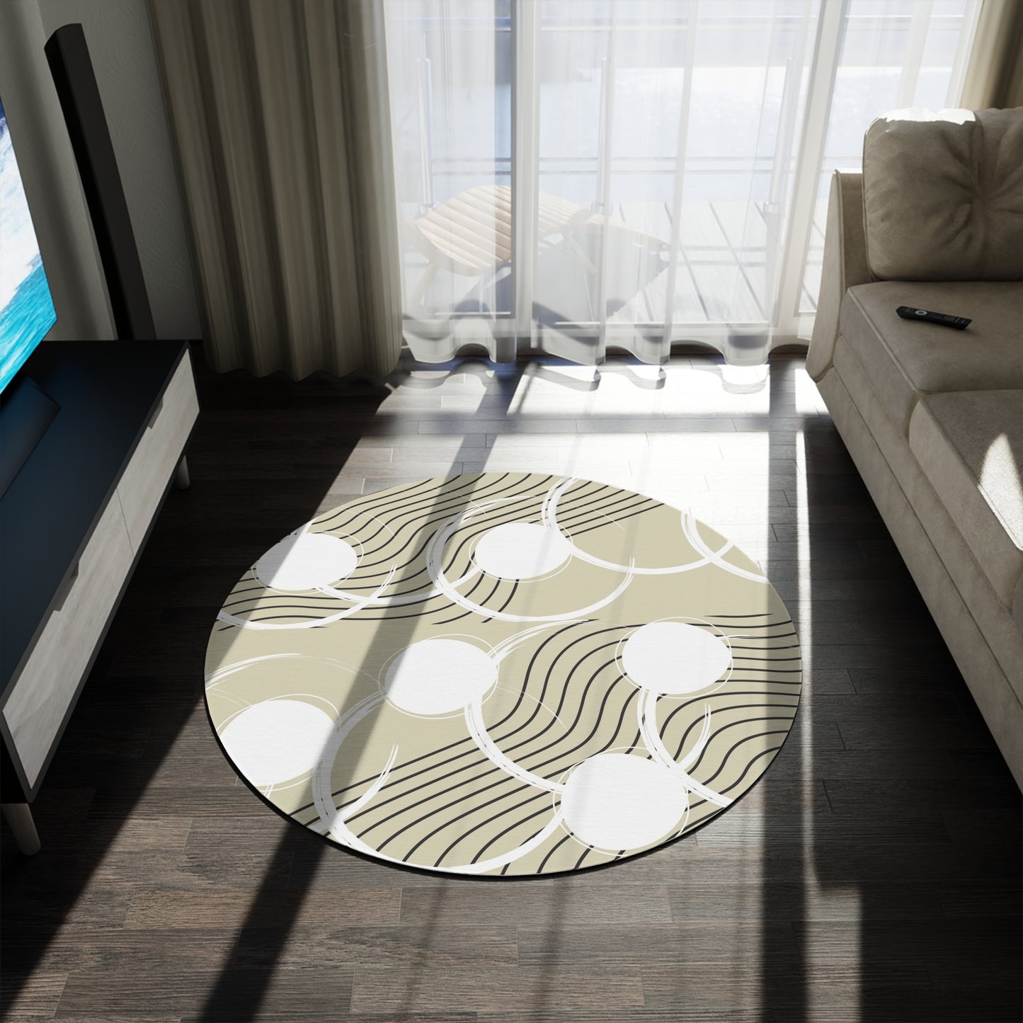 neutral colored round area rug with a cream tan colored base with white circles and black abstract lines