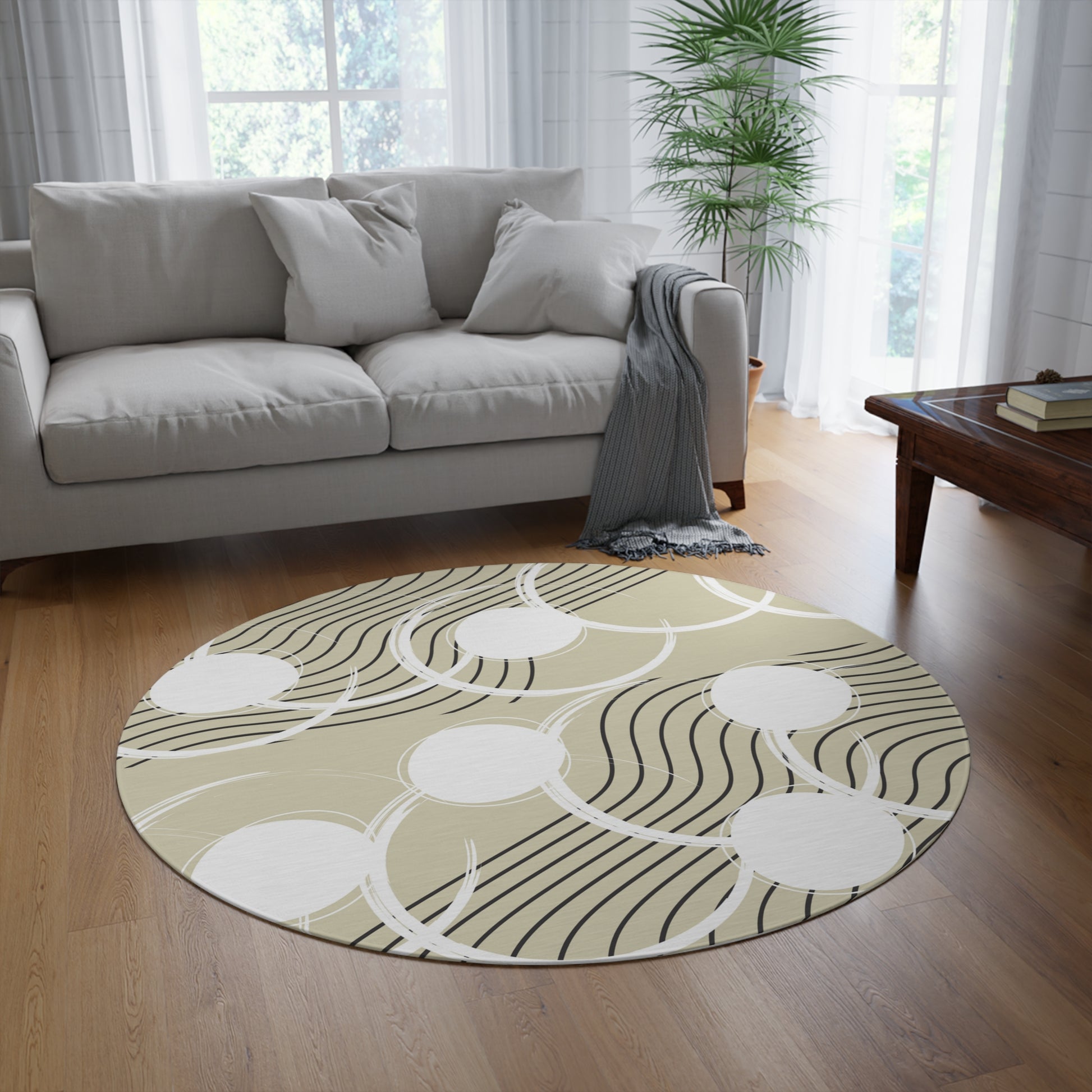 neutral colored round area rug with a cream tan colored base with white circles and black abstract lines