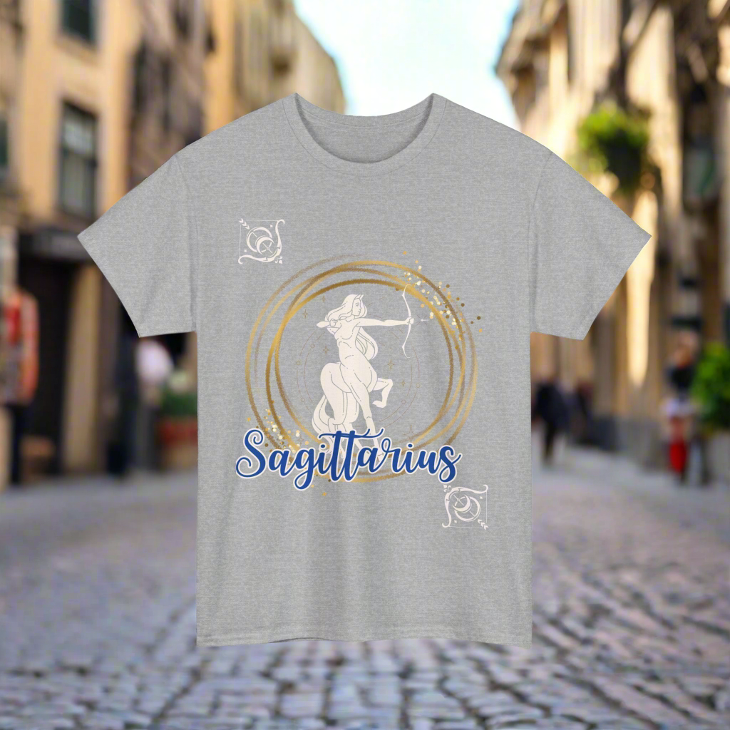 Sagittarius Horoscope tshirt with the Sagittarius symbol in white with gold stacked rings circling it. Smaller white arrows in diagonal corners with Sagittarius printed in blue cursive lettering with white outline - grey shirt