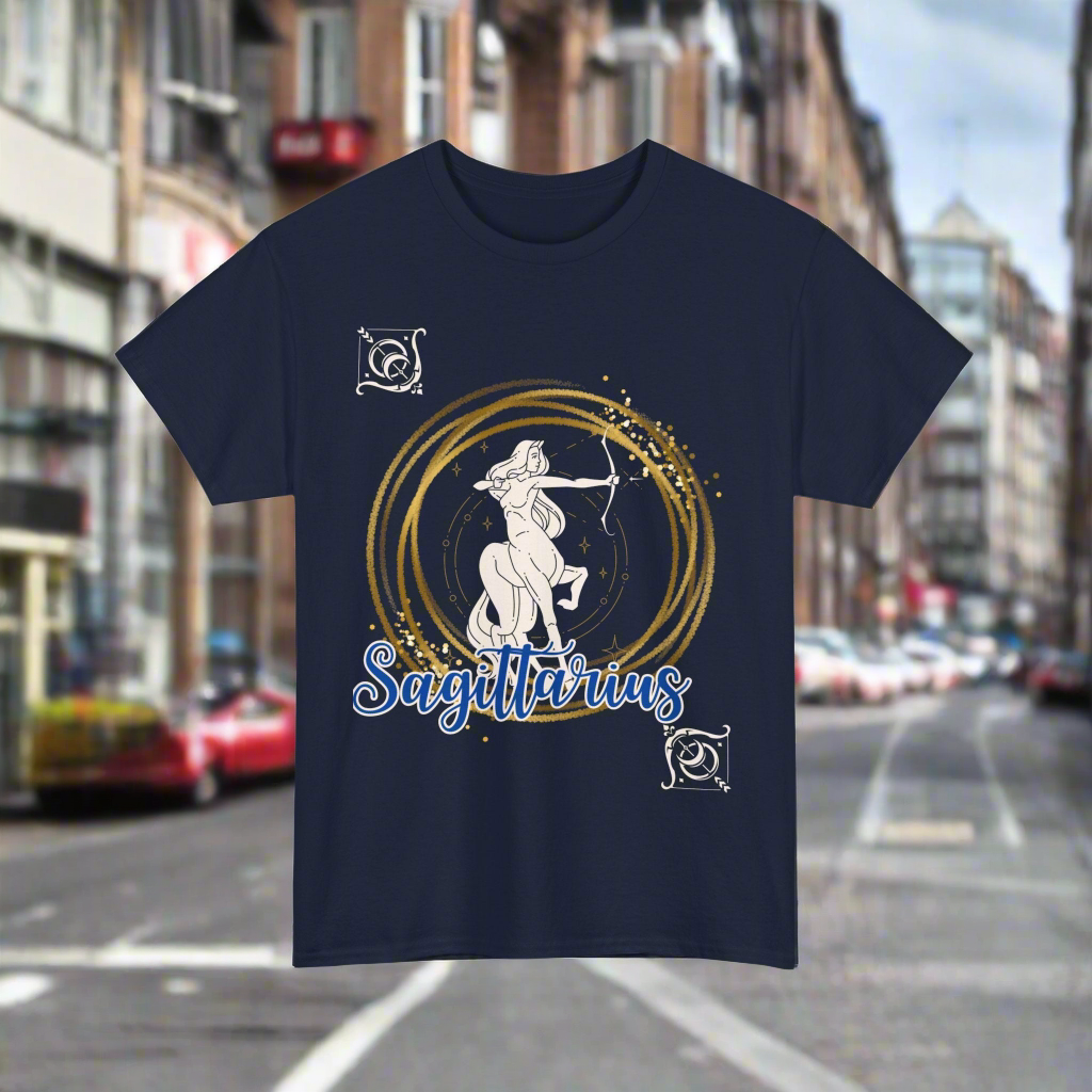 Sagittarius Horoscope tshirt with the Sagittarius symbol in white with gold stacked rings circling it. Smaller white arrows in diagonal corners with Sagittarius printed in blue cursive lettering with white outline - navy shirt