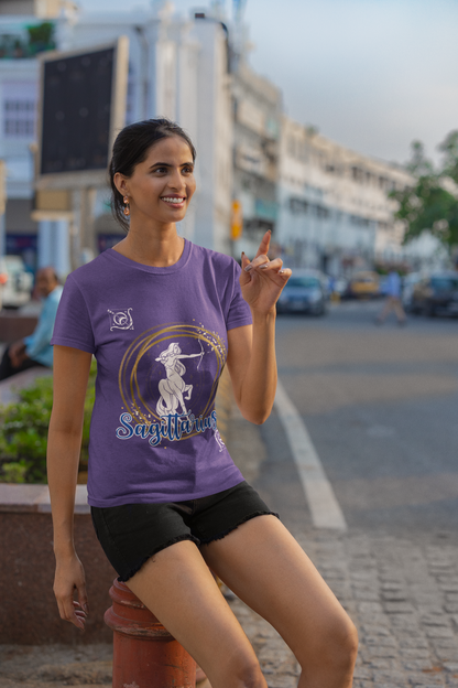 Sagittarius Horoscope tshirt with the Sagittarius symbol in white with gold stacked rings circling it. Smaller white arrows in diagonal corners with Sagittarius printed in blue cursive lettering with white outline - purple shirt