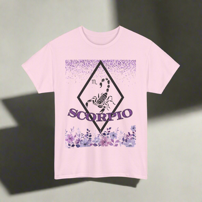 Scorpio Horoscope tshirt with falling purple glitter, a hollow white diamond with a white scorpion in the center. Scorpio printed in purple font with white outline over more fading purple glitter - light pink shirt 