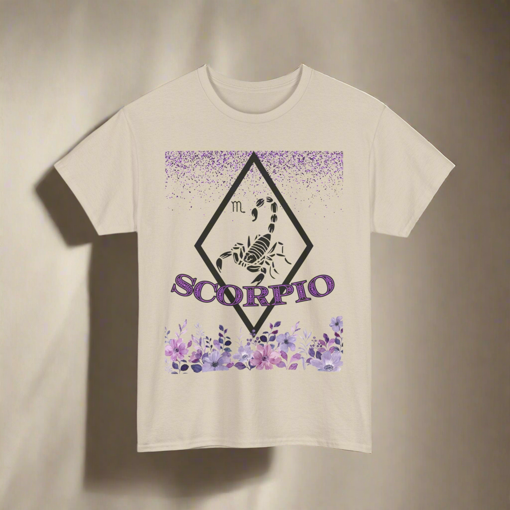 Scorpio Horoscope tshirt with falling purple glitter, a hollow white diamond with a white scorpion in the center. Scorpio printed in purple font with white outline over more fading purple glitter - sand beige shirt 