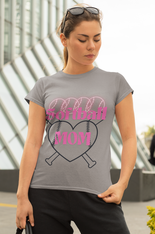 Softball Mom tshirt- four neon pink softballs across the top Softball MOM in the center in a bright pink retro font with two black outline baseball bats and a heart with thread lines In the background - grey