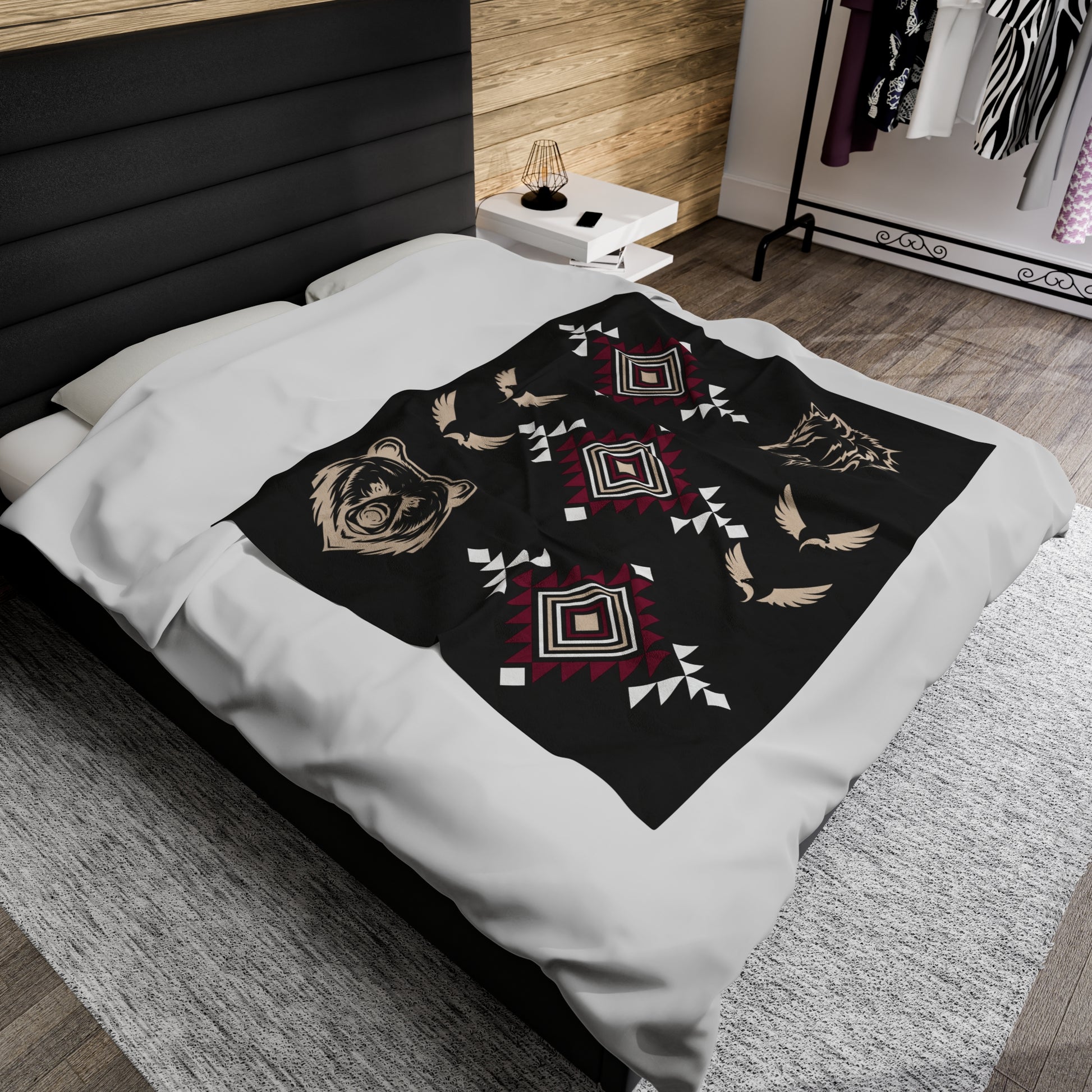 This beautiful velveteen plush blanket features a black background wth tribal patterns diagonally printed from top to bottom corners in burgundy, beige, and white. The top section has wolf to the right, the mid section has eagles all the way around, a bear to the left across the bottom section.