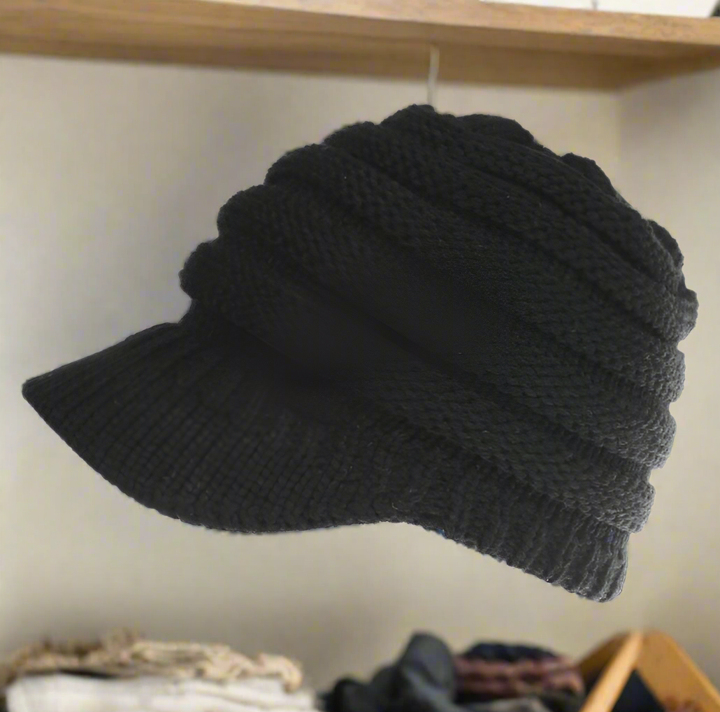 Womens Ponytail beanie in the black color. Versatile for any outfit. The perfect combo of cute and comfy. Keep your head warm and have an effortless hair day!